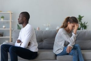 unhappy married couple sits on the bed after arguing. They get help from marriage counseling and couples therapy in katy, tx near Houston at the counseling center at cinco ranch, 77494