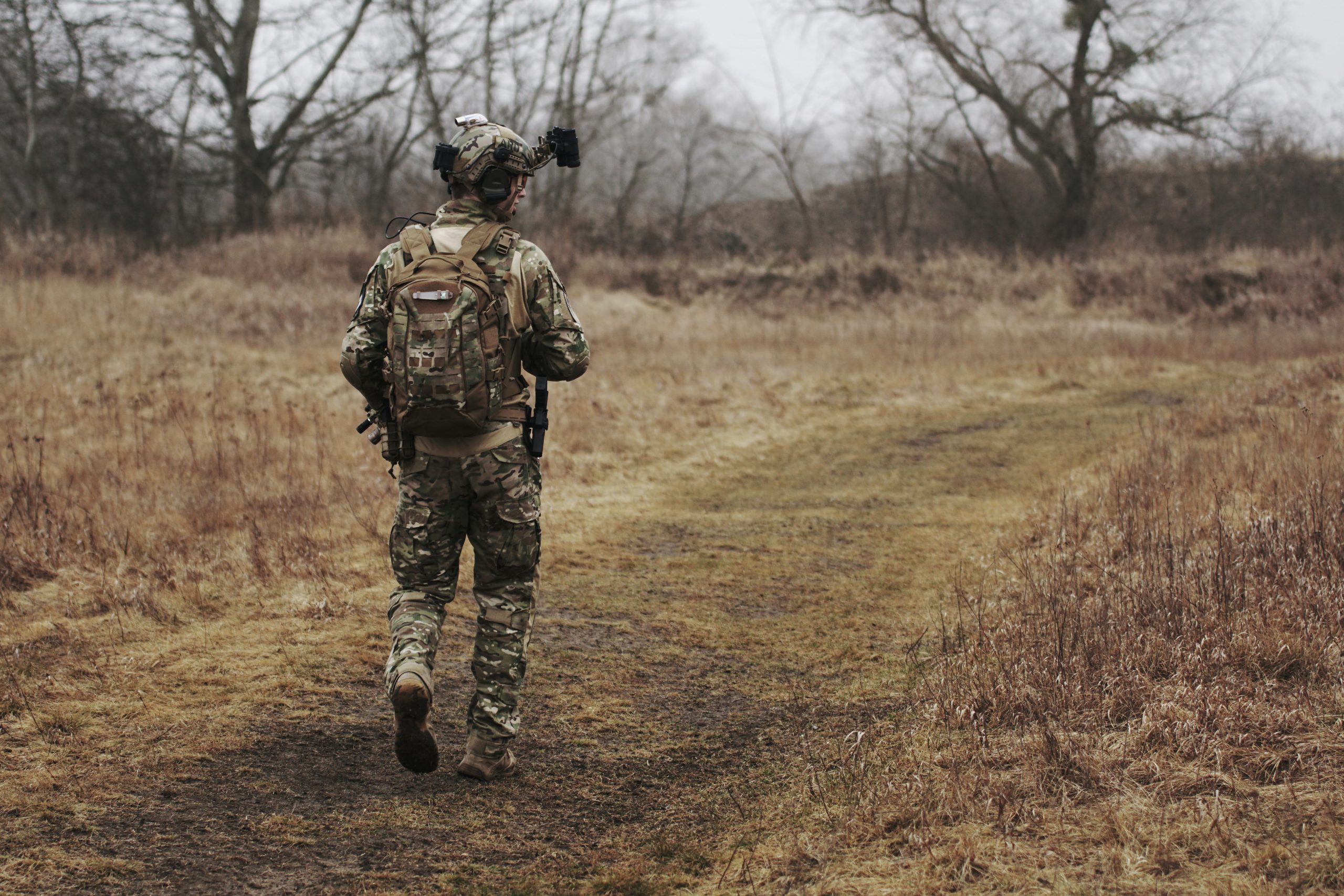 Soldier walking in an open field after receiving help for PTSD