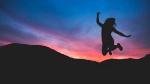 a woman jumping from joy after learning how to handle work stress from counseling in Katy, TX 77494