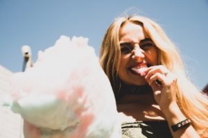 A girl eating cotton candy learning to love her body after being in body group in Katy, TX 77494