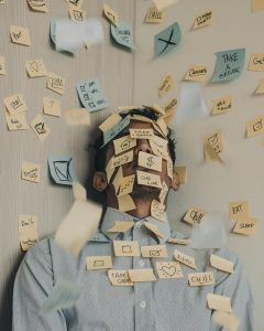 A young man with sticky notes all over his body that represent stress in his life. Represents the need for counseling for perfectionism in Katy, TX