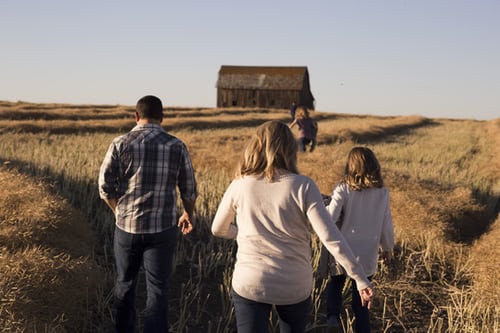 A family running on a farm having fun. Represents the need for parenting therapy in Katy, TX 77494