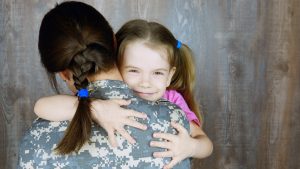 Mom holding her child, child smiling, military family, How to help your child cope with separation anxiety blog, Counseling center at cinco ranch, begin counseling in katy texas, fulshear texas, richmond texas
