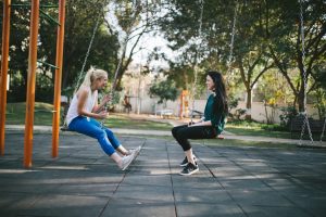 two women swinging on a swing, laughing, the importance of nonverbal communication blog, counseling center at cinco ranch, therapy, katy texas