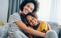 Lovely mother embracing her cute daughter on the sofa at home, How to Motivate Kids in a Healthy Way blog, counseling center at cinco ranch, counseling in katy texas, richmond texas