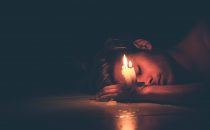 girl on the floor with a candle burning, burning the candle at both ends, depression blog, signs to look for, counseling center at cinco ranch, katy texas 77494
