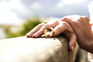 a person holding a wedding ring that has been taken off, thinking about divorce, overcoming a gray divorce blog, counseling center at cinco ranch, katy texas, fulshear texas